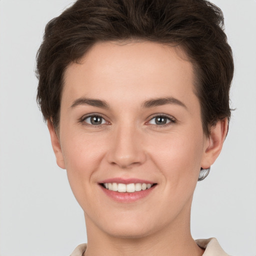 Joyful white young-adult female with short  brown hair and brown eyes