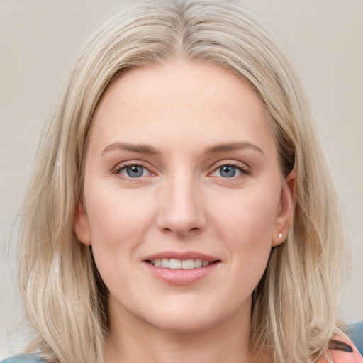 Joyful white young-adult female with medium  brown hair and blue eyes