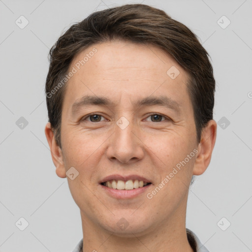 Joyful white adult male with short  brown hair and brown eyes