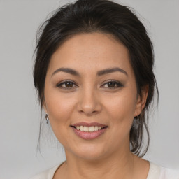 Joyful latino young-adult female with medium  brown hair and brown eyes