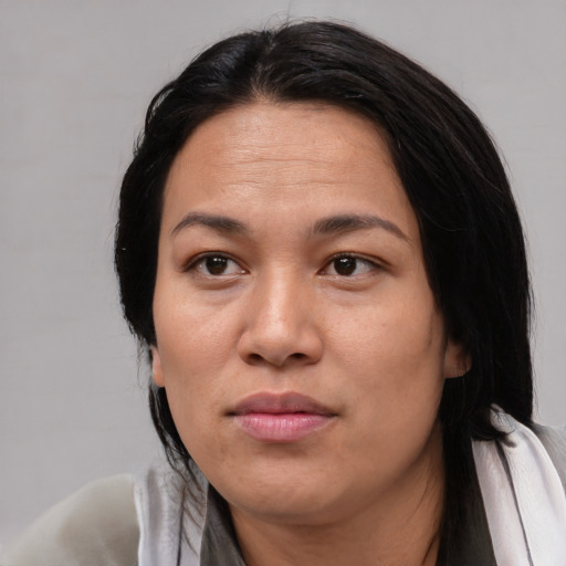 Neutral asian adult female with medium  black hair and brown eyes