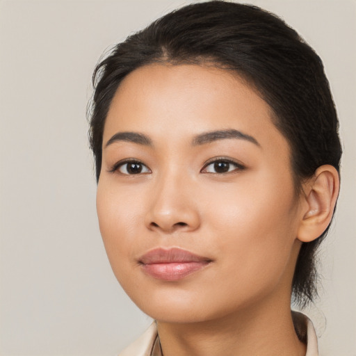 Joyful latino young-adult female with long  black hair and brown eyes