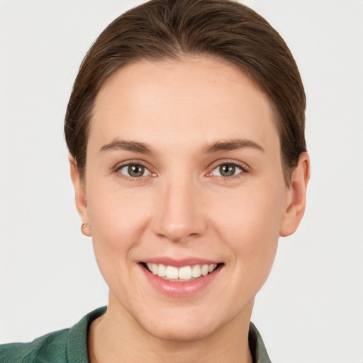 Joyful white young-adult female with short  brown hair and grey eyes