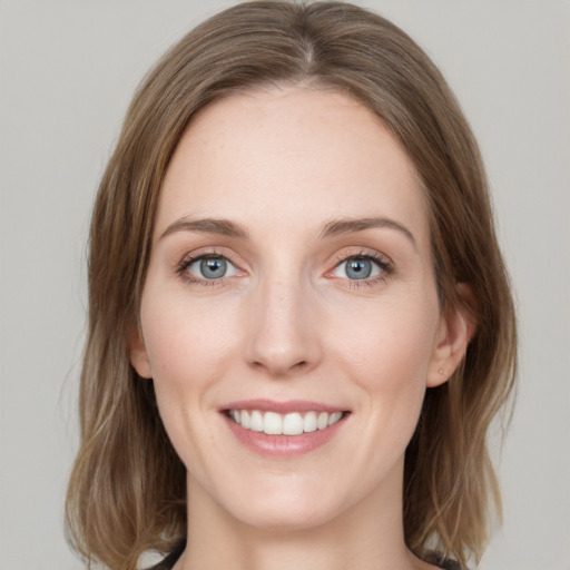 Joyful white young-adult female with medium  brown hair and blue eyes