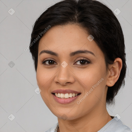 Joyful latino young-adult female with medium  brown hair and brown eyes