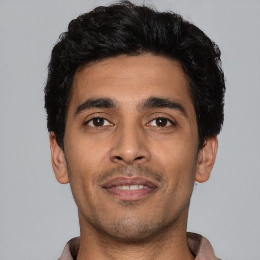 Joyful latino young-adult male with short  black hair and brown eyes