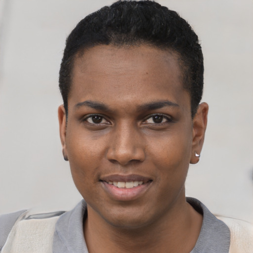 Joyful black young-adult male with short  black hair and brown eyes