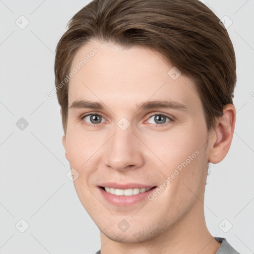 Joyful white young-adult male with short  brown hair and grey eyes