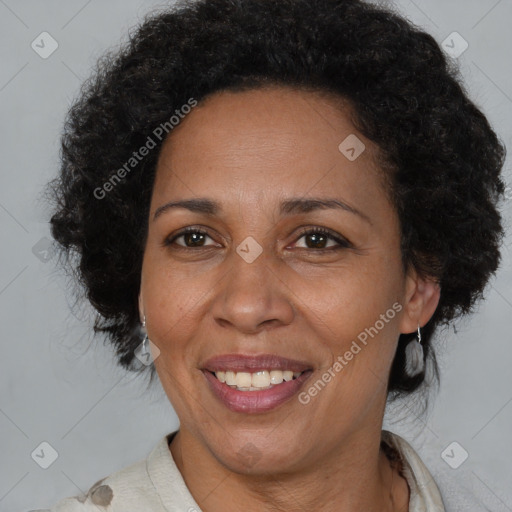 Joyful black adult female with short  brown hair and brown eyes