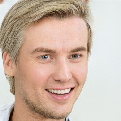 Joyful white young-adult male with short  brown hair and blue eyes