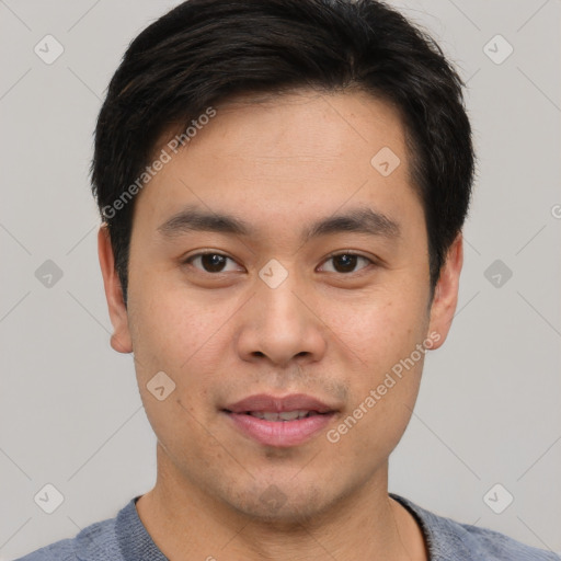 Joyful asian young-adult male with short  brown hair and brown eyes