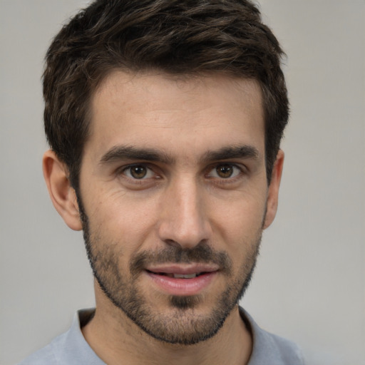 Joyful white young-adult male with short  black hair and brown eyes