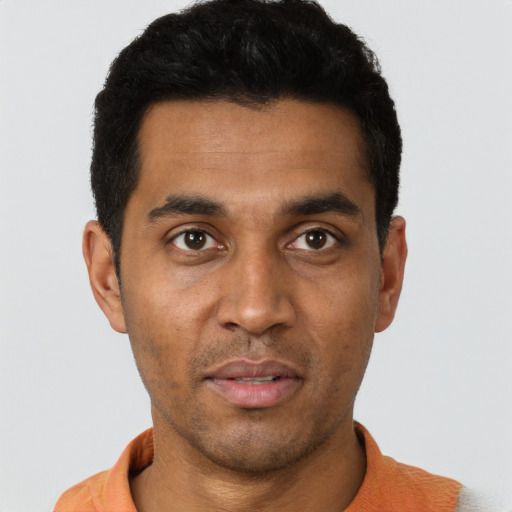 Joyful black young-adult male with short  black hair and brown eyes