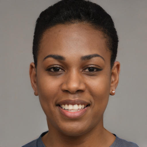 Joyful black young-adult female with short  black hair and brown eyes