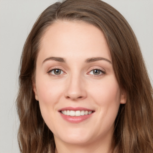 Joyful white young-adult female with long  brown hair and brown eyes