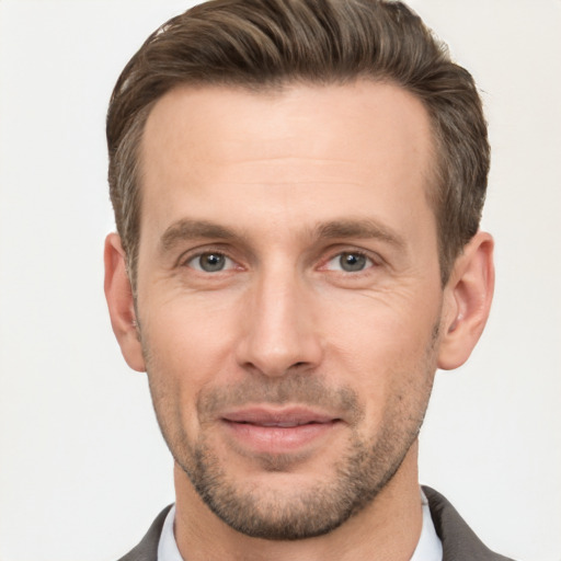 Joyful white adult male with short  brown hair and brown eyes