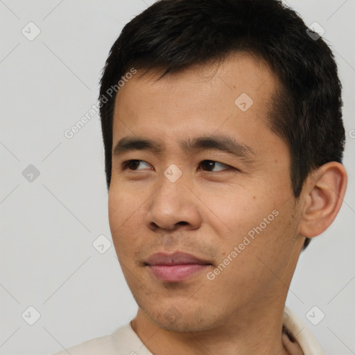 Joyful asian young-adult male with short  black hair and brown eyes