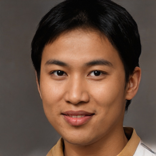 Joyful asian young-adult male with short  brown hair and brown eyes