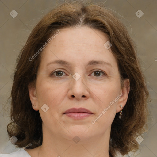 Joyful white adult female with medium  brown hair and brown eyes