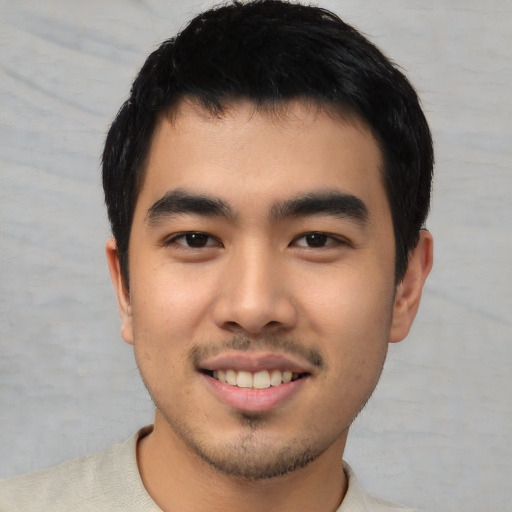 Joyful asian young-adult male with short  black hair and brown eyes