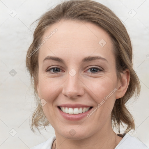 Joyful white young-adult female with medium  brown hair and grey eyes