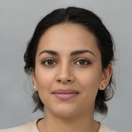 Joyful latino young-adult female with medium  brown hair and brown eyes
