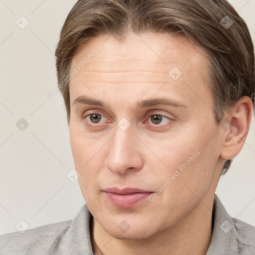 Joyful white adult male with short  brown hair and grey eyes