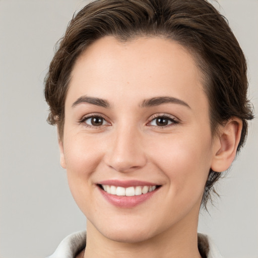 Joyful white young-adult female with medium  brown hair and brown eyes