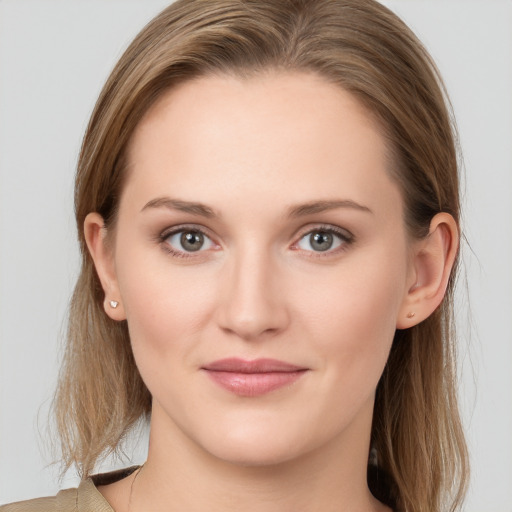 Joyful white young-adult female with long  brown hair and grey eyes