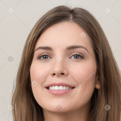 Joyful white young-adult female with long  brown hair and grey eyes