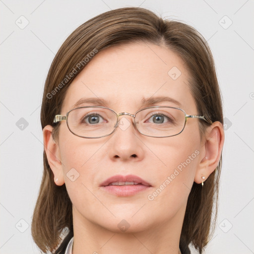 Joyful white adult female with long  brown hair and blue eyes