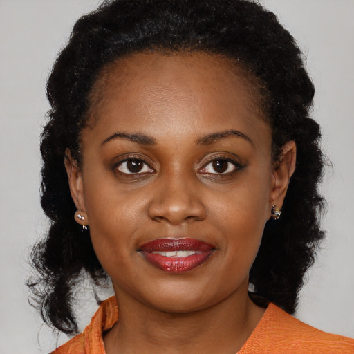 Joyful black young-adult female with medium  black hair and brown eyes