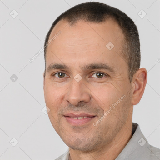 Joyful white adult male with short  brown hair and brown eyes