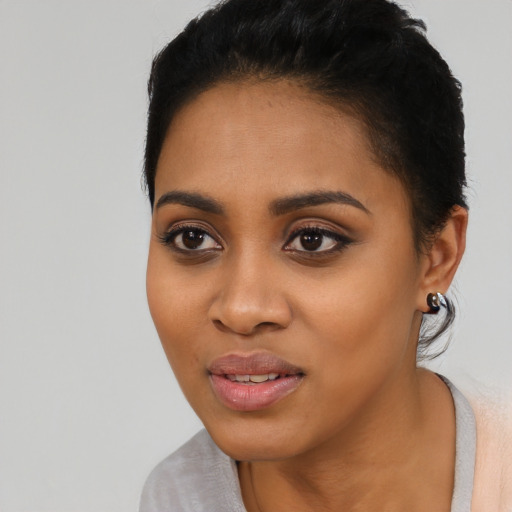 Joyful latino young-adult female with short  black hair and brown eyes