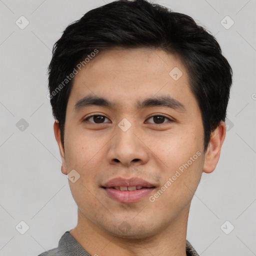 Joyful asian young-adult male with short  black hair and brown eyes