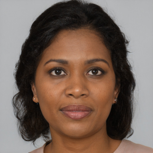 Joyful black young-adult female with medium  brown hair and brown eyes