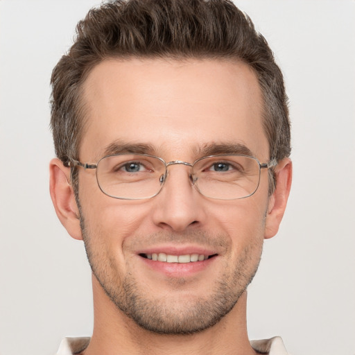 Joyful white adult male with short  brown hair and grey eyes