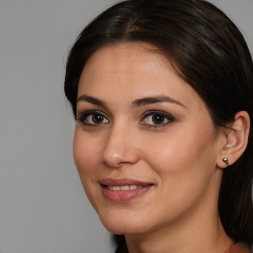 Joyful white young-adult female with medium  brown hair and brown eyes