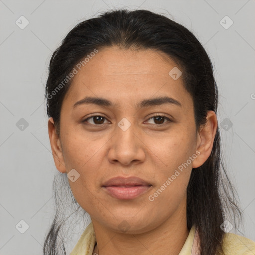 Joyful latino adult female with medium  brown hair and brown eyes