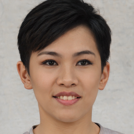 Joyful asian young-adult female with short  black hair and brown eyes