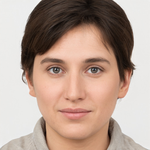 Joyful white young-adult female with short  brown hair and brown eyes