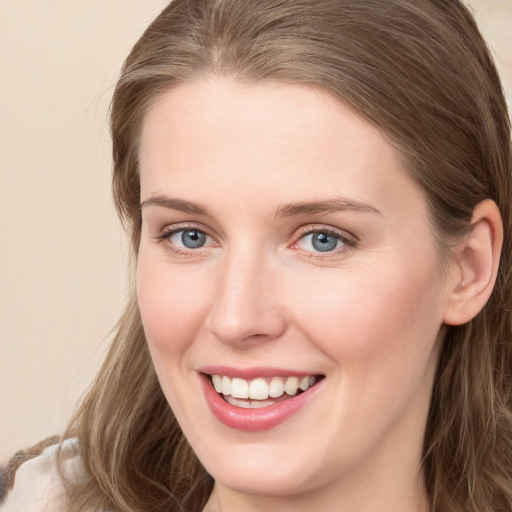 Joyful white young-adult female with long  brown hair and grey eyes