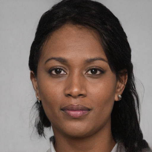 Joyful black young-adult female with medium  black hair and brown eyes