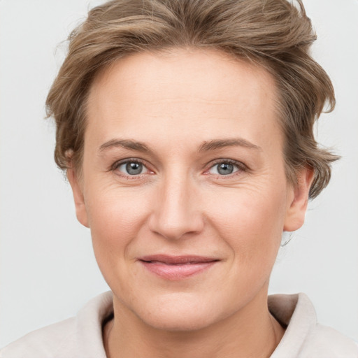 Joyful white adult female with short  brown hair and grey eyes