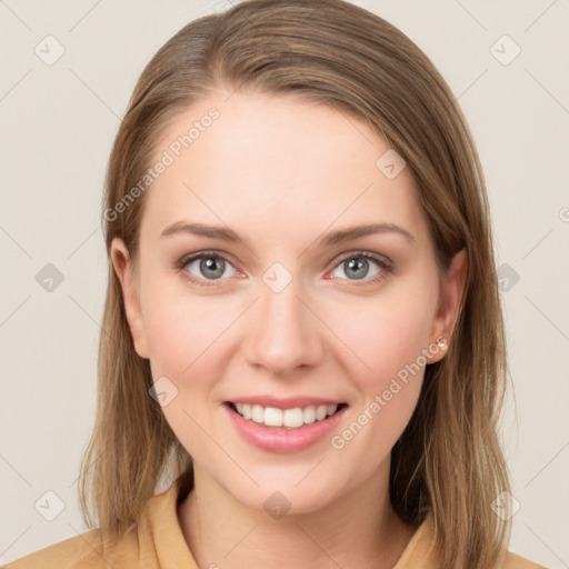 Joyful white young-adult female with long  brown hair and grey eyes