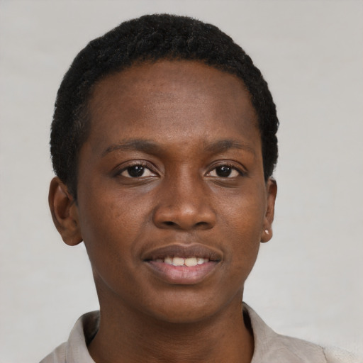 Joyful black young-adult male with short  brown hair and brown eyes