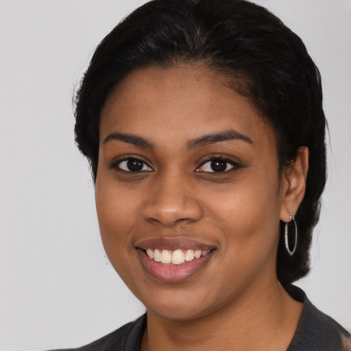 Joyful black young-adult female with medium  black hair and brown eyes