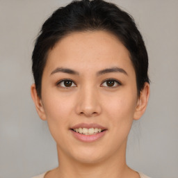 Joyful asian young-adult female with short  brown hair and brown eyes