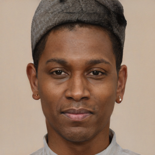 Joyful black young-adult male with short  black hair and brown eyes