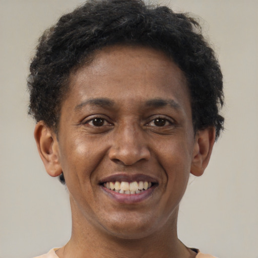 Joyful black adult male with short  brown hair and brown eyes